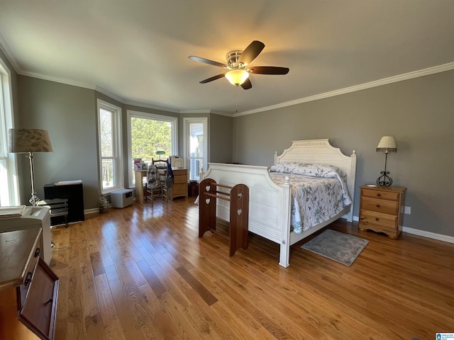 bedroom with baseboards, ceiling fan, light wood finished floors, and crown molding