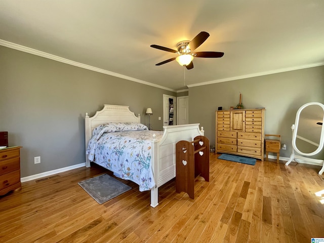 bedroom featuring a ceiling fan, baseboards, wood finished floors, and ornamental molding