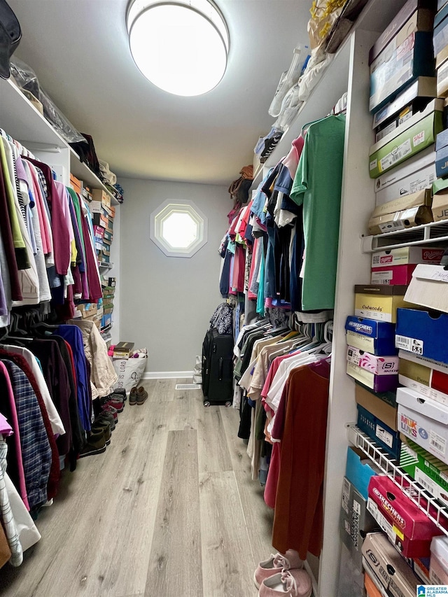 spacious closet featuring wood finished floors