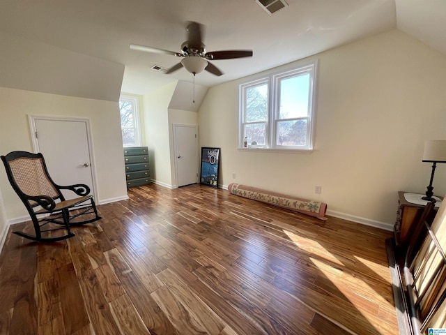 additional living space with dark wood-style floors, visible vents, vaulted ceiling, and a wealth of natural light