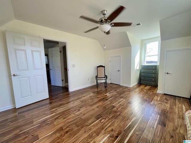 interior space with lofted ceiling, visible vents, ceiling fan, wood finished floors, and baseboards