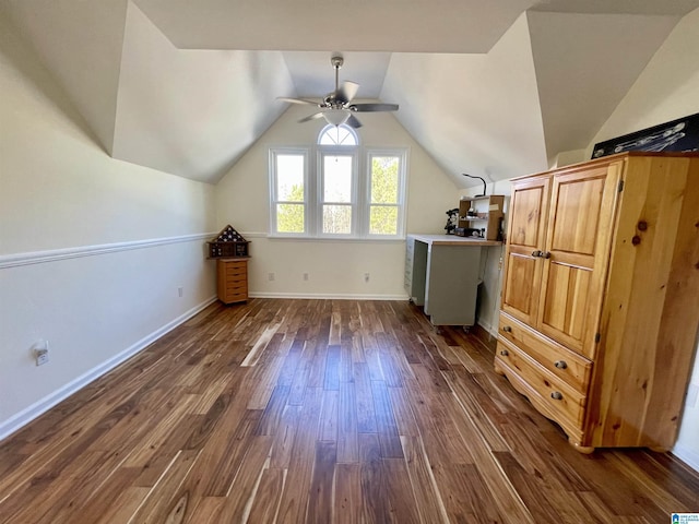 additional living space with ceiling fan, vaulted ceiling, baseboards, and dark wood finished floors