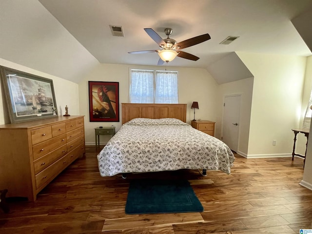 bedroom featuring vaulted ceiling, visible vents, and dark wood finished floors