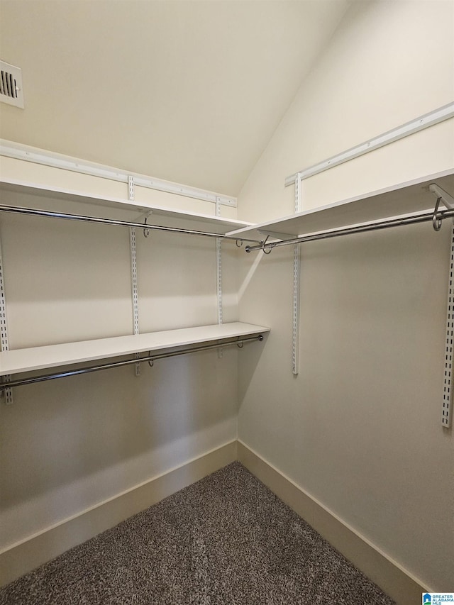 walk in closet with lofted ceiling and visible vents