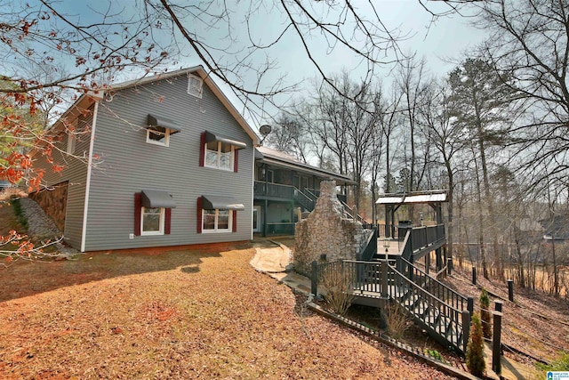 rear view of property with stairway