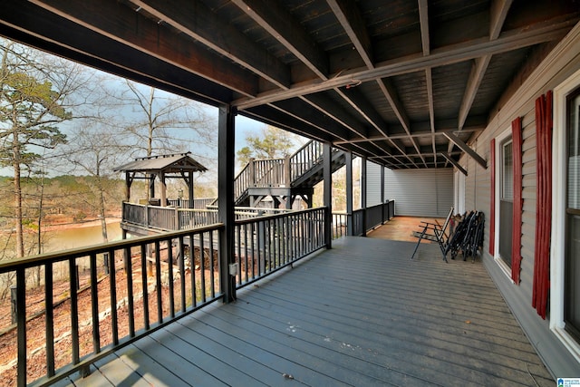 wooden terrace featuring a gazebo and stairs