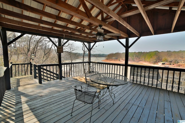 wooden terrace featuring ceiling fan and outdoor dining space