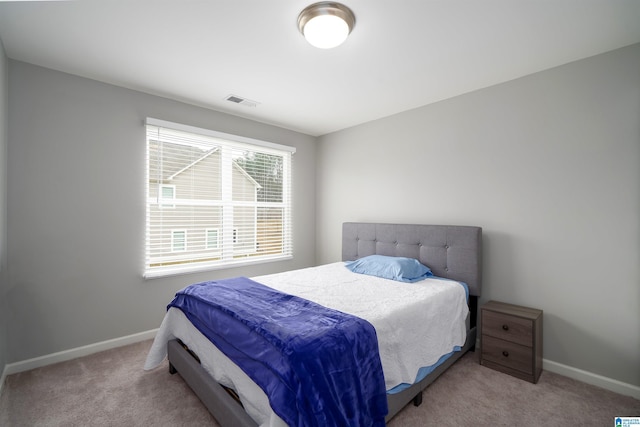 bedroom featuring carpet floors, visible vents, and baseboards