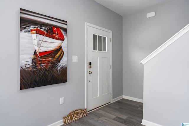 entrance foyer featuring baseboards and wood finished floors