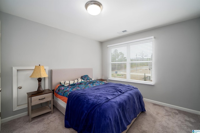 carpeted bedroom with baseboards and visible vents