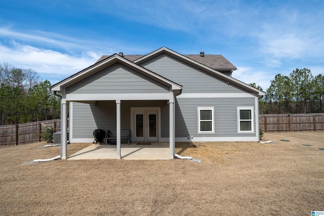 rear view of house featuring french doors, a patio area, and a fenced backyard