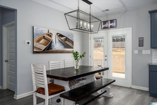 dining room with french doors, visible vents, dark wood finished floors, and baseboards