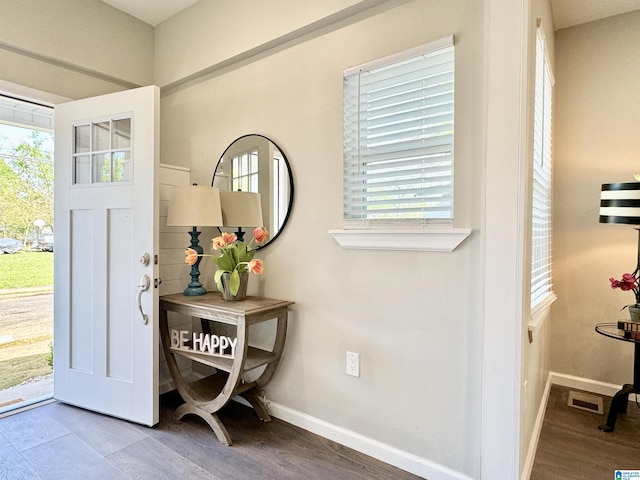 entryway with visible vents, baseboards, and wood finished floors