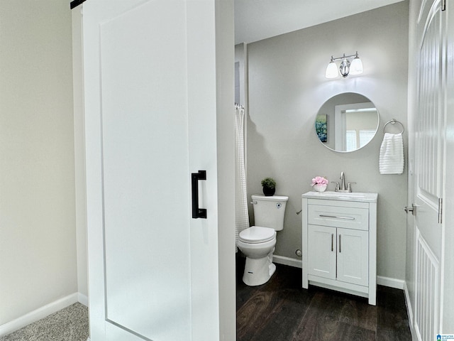 full bathroom featuring baseboards, vanity, and toilet