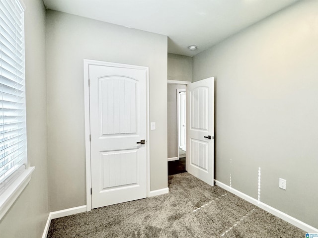 unfurnished bedroom with carpet and baseboards