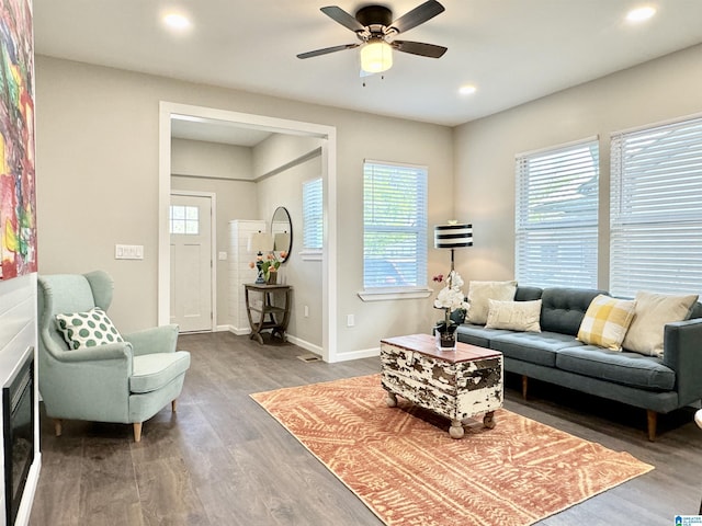 living area with a ceiling fan, recessed lighting, baseboards, and wood finished floors