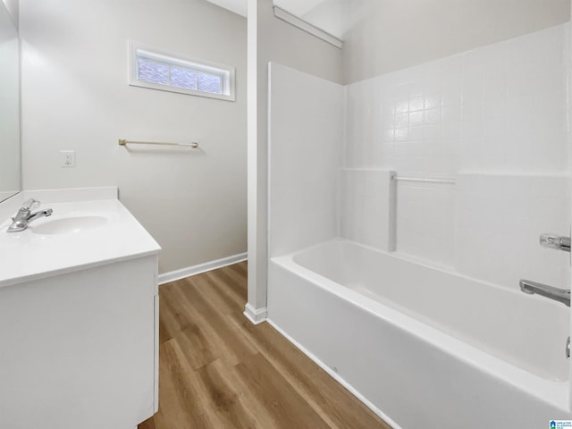 full bathroom featuring shower / bath combination, vanity, baseboards, and wood finished floors