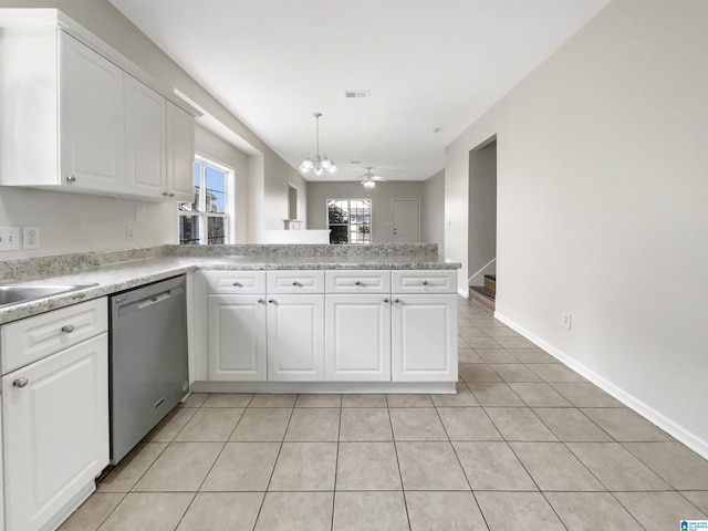 kitchen with white cabinetry, a peninsula, stainless steel dishwasher, and light tile patterned floors