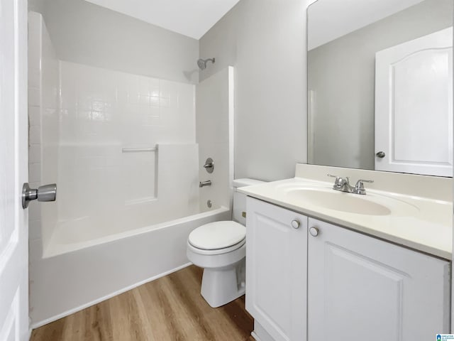 full bath with shower / bathtub combination, vanity, toilet, and wood finished floors