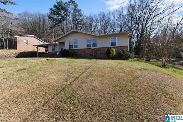 ranch-style home with brick siding and a front lawn