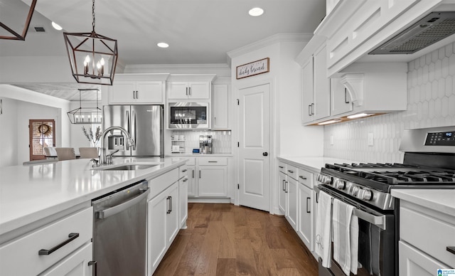 kitchen with light countertops, custom range hood, appliances with stainless steel finishes, white cabinets, and a sink