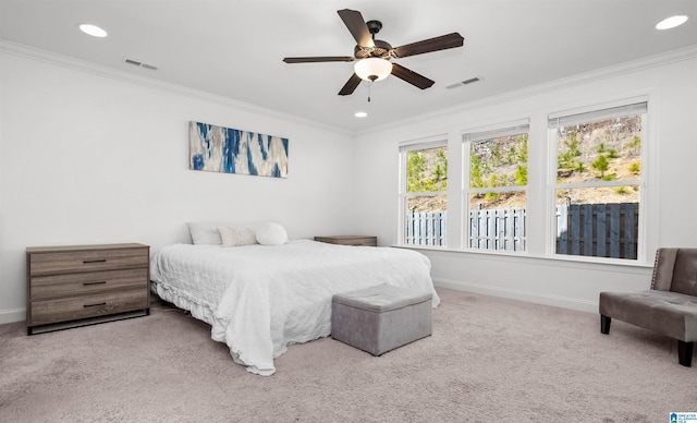 carpeted bedroom featuring recessed lighting, baseboards, visible vents, and ornamental molding