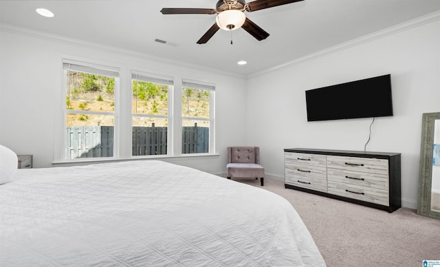 bedroom featuring visible vents, ornamental molding, carpet floors, baseboards, and ceiling fan