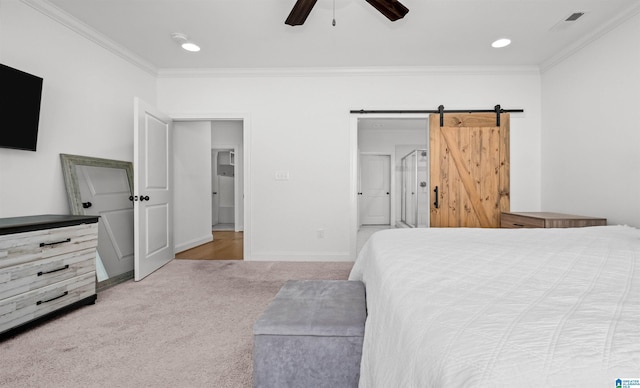 carpeted bedroom with a barn door, recessed lighting, crown molding, and baseboards