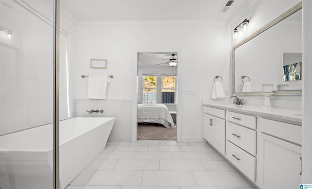 ensuite bathroom with a sink, ornamental molding, visible vents, and connected bathroom