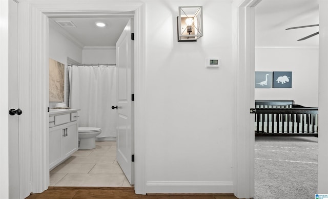 bathroom with visible vents, toilet, ornamental molding, tile patterned floors, and a ceiling fan