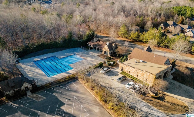 community pool featuring a wooded view