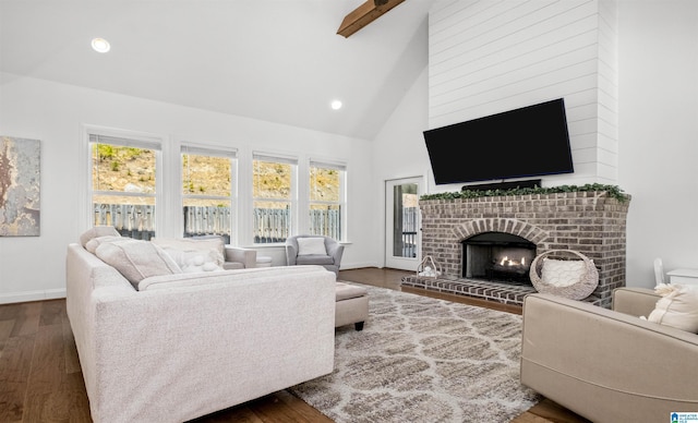 living room with a healthy amount of sunlight, a fireplace, and dark wood-style flooring