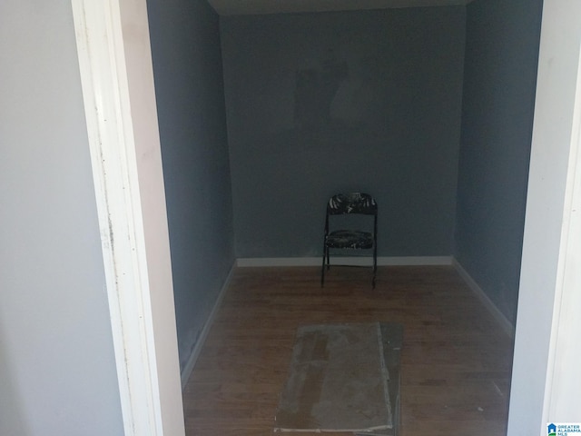 empty room with baseboards and wood finished floors