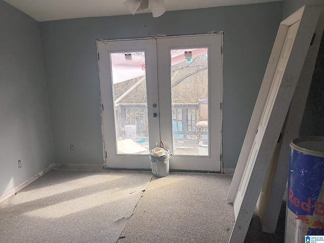 entryway with french doors, a wealth of natural light, and baseboards