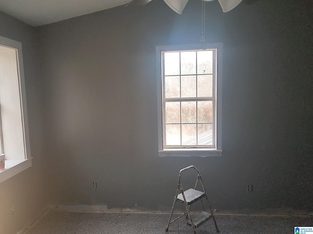 unfurnished room with vaulted ceiling