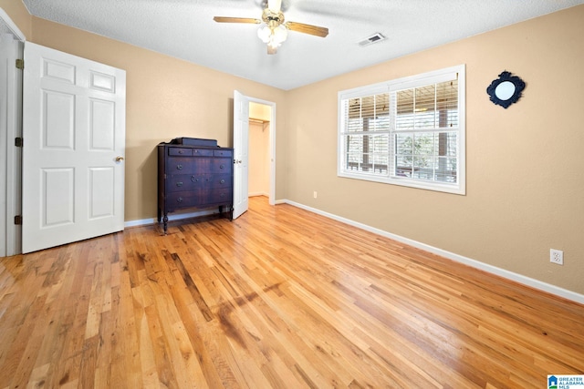 unfurnished bedroom with visible vents, baseboards, and wood finished floors