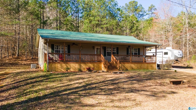 chalet / cabin featuring covered porch, ceiling fan, central AC unit, and metal roof