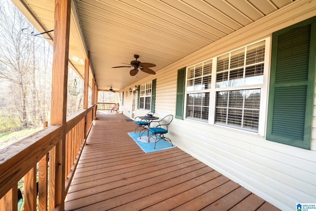 wooden deck with covered porch and a ceiling fan