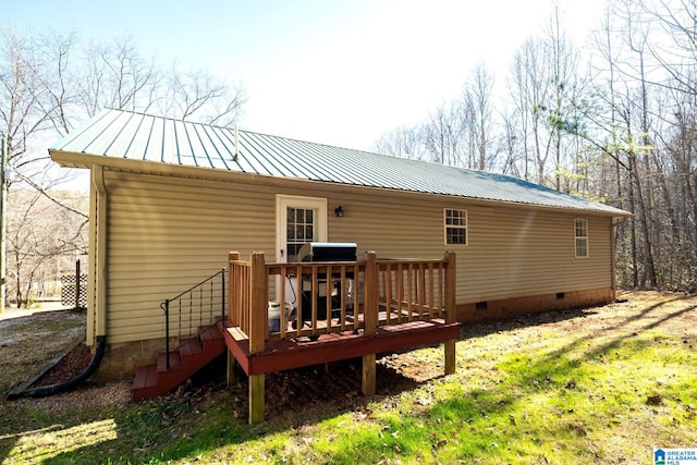 rear view of house featuring crawl space, metal roof, and a deck