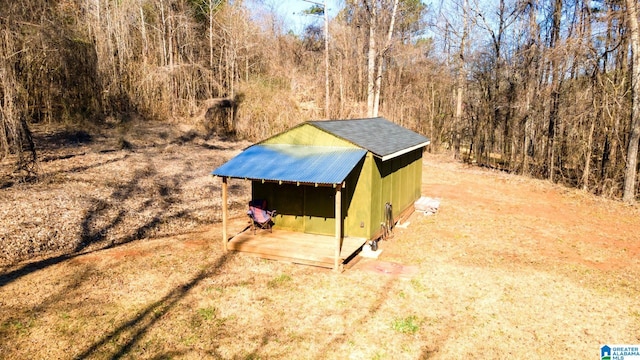 view of shed with a view of trees