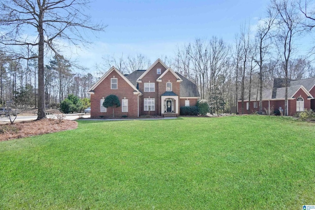 view of front of house featuring a front lawn and brick siding