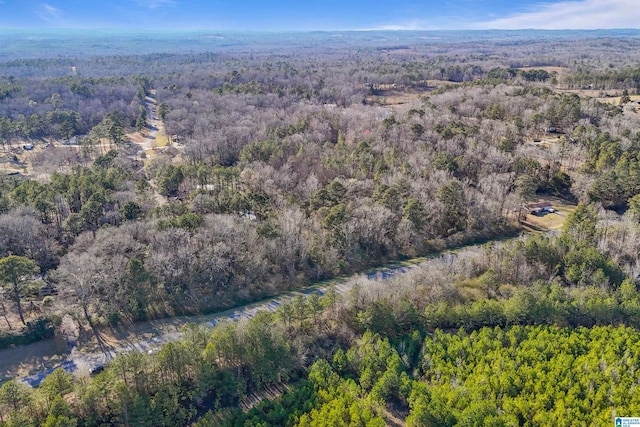 drone / aerial view featuring a wooded view