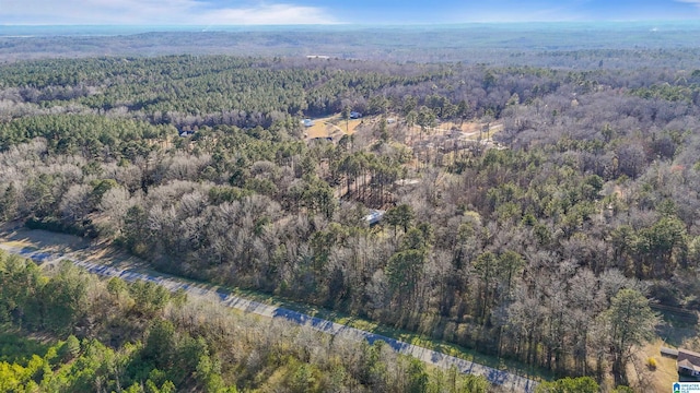 drone / aerial view featuring a forest view