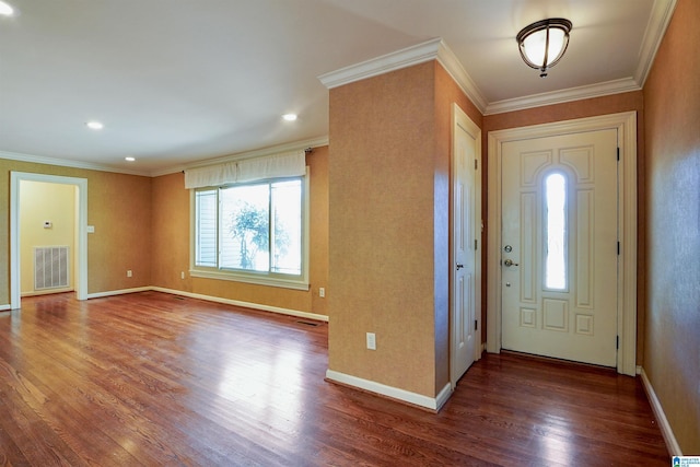 foyer featuring ornamental molding, visible vents, baseboards, and wood finished floors