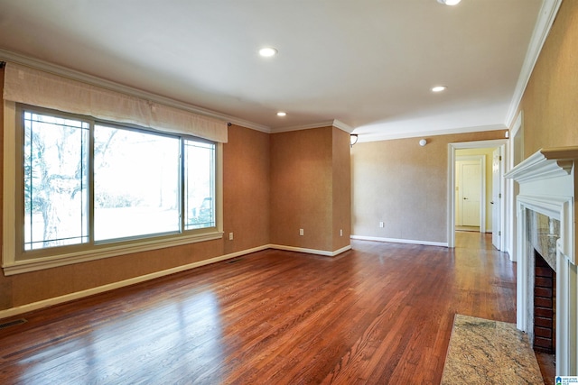 unfurnished living room with a fireplace, recessed lighting, ornamental molding, wood finished floors, and baseboards