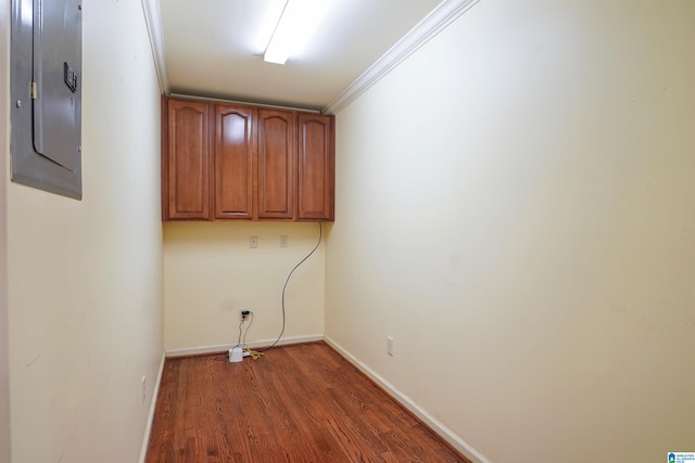 washroom with baseboards, dark wood finished floors, electric panel, and crown molding