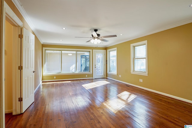 empty room featuring crown molding, recessed lighting, ceiling fan, wood finished floors, and baseboards