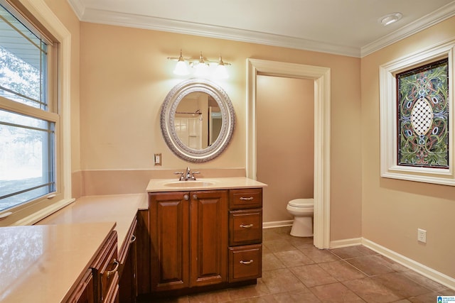 bathroom with toilet, ornamental molding, vanity, baseboards, and tile patterned floors