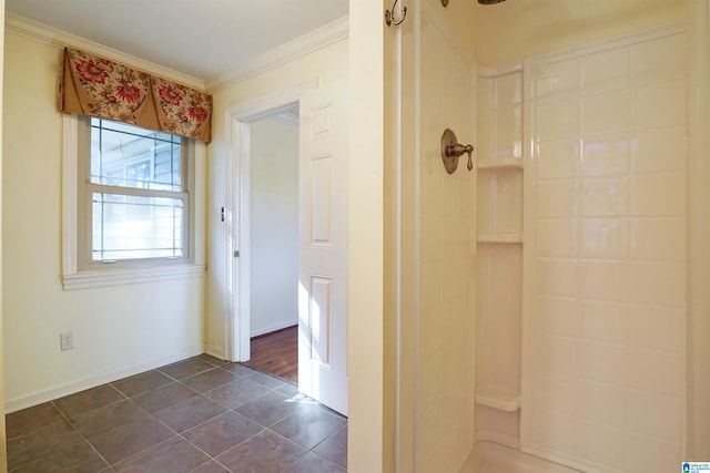 full bath featuring ornamental molding, tile patterned floors, baseboards, and walk in shower