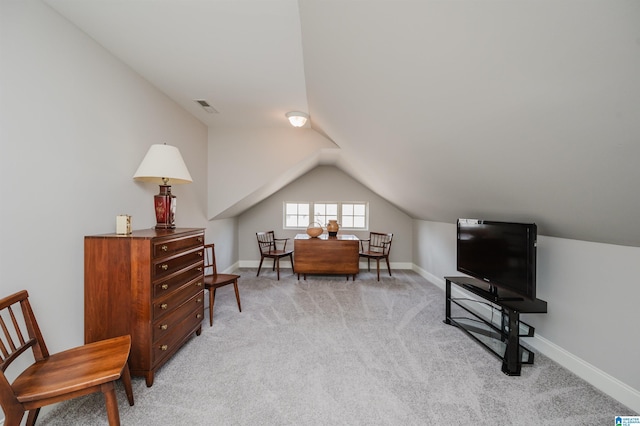 sitting room featuring light carpet, vaulted ceiling, visible vents, and baseboards